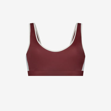 Red and white sports swim top with scoop neckline, eco stretch fabric, designed for water sports, on white background
